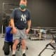 A man with cerebral palsy stands in a gait laboratory while a therapist applies the markers before a gait analysis.